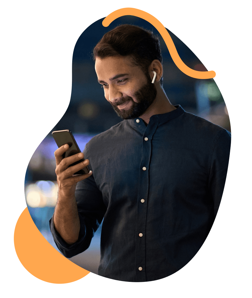 A photograph of a man looking at his phone.