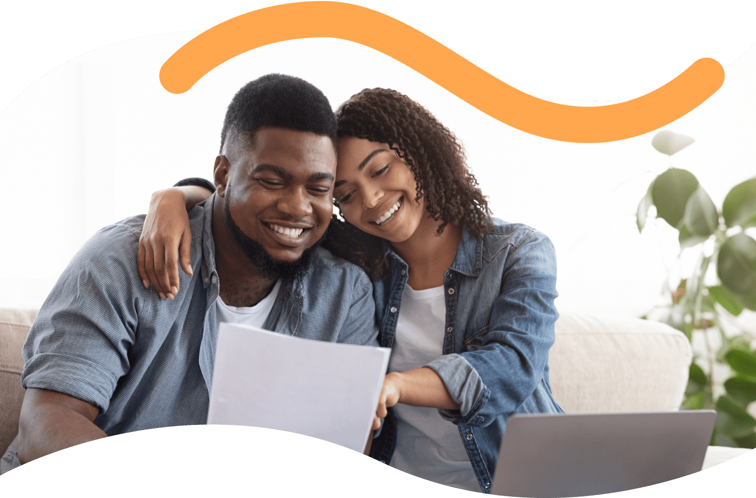 A photograph of a couple smiling whilst checking some documents.